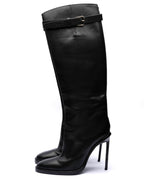 Black knee-high boot with high heel on a white background