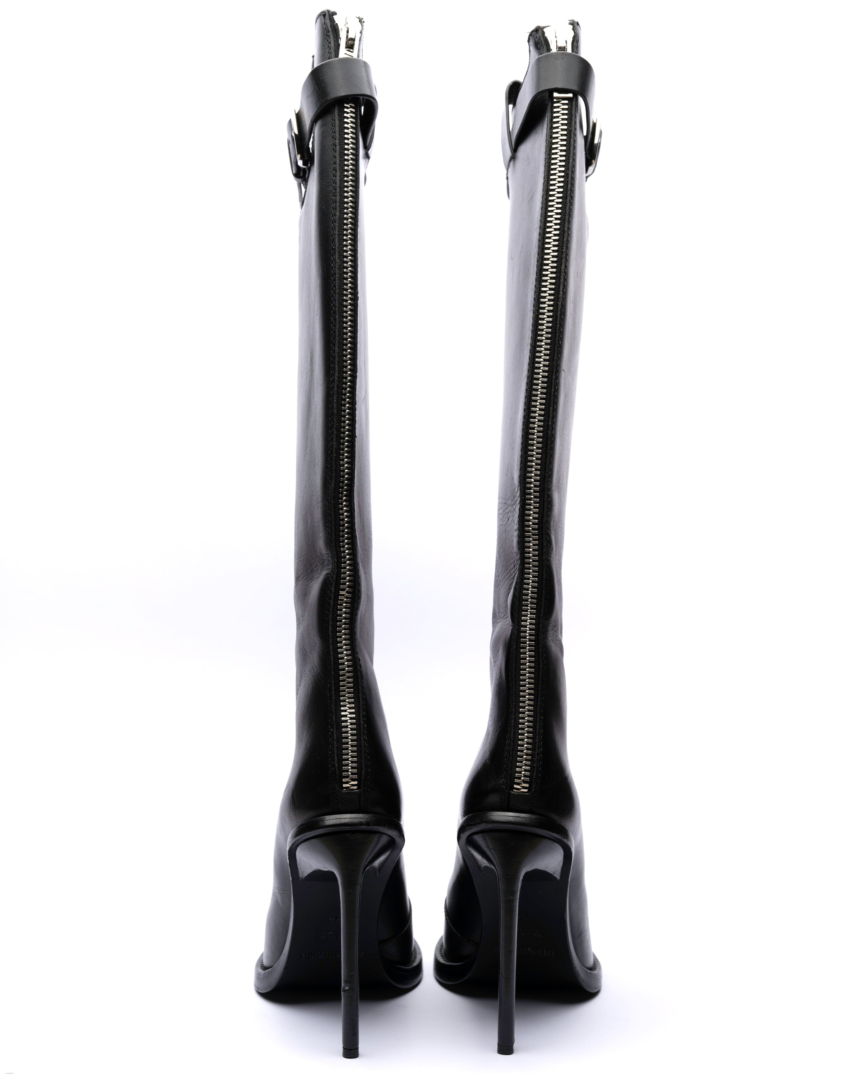 Black knee-high boots with zippers on a white background