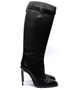 Black knee-high boot with a high heel on a white background